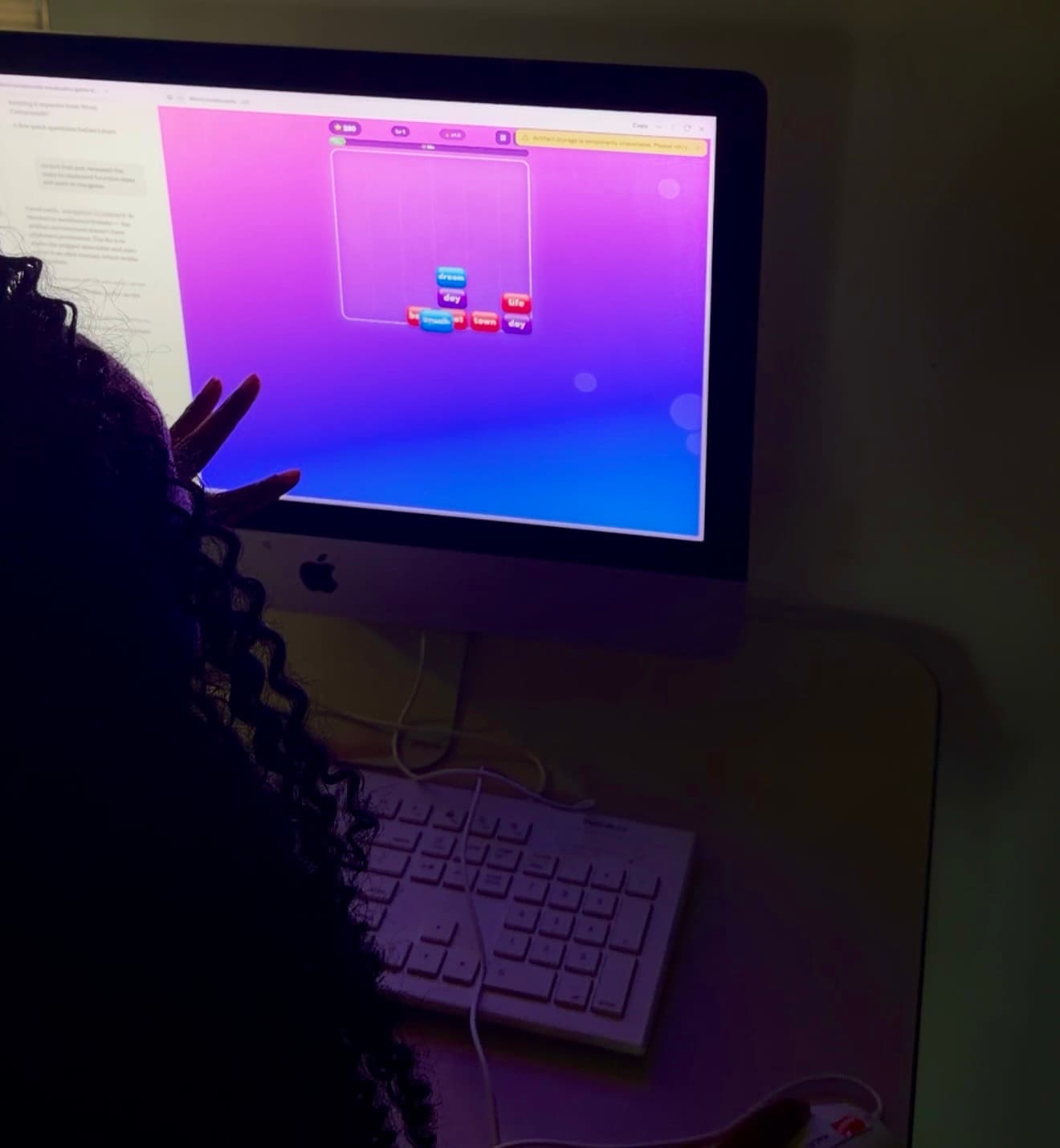 A student testing a word-building game at a computer